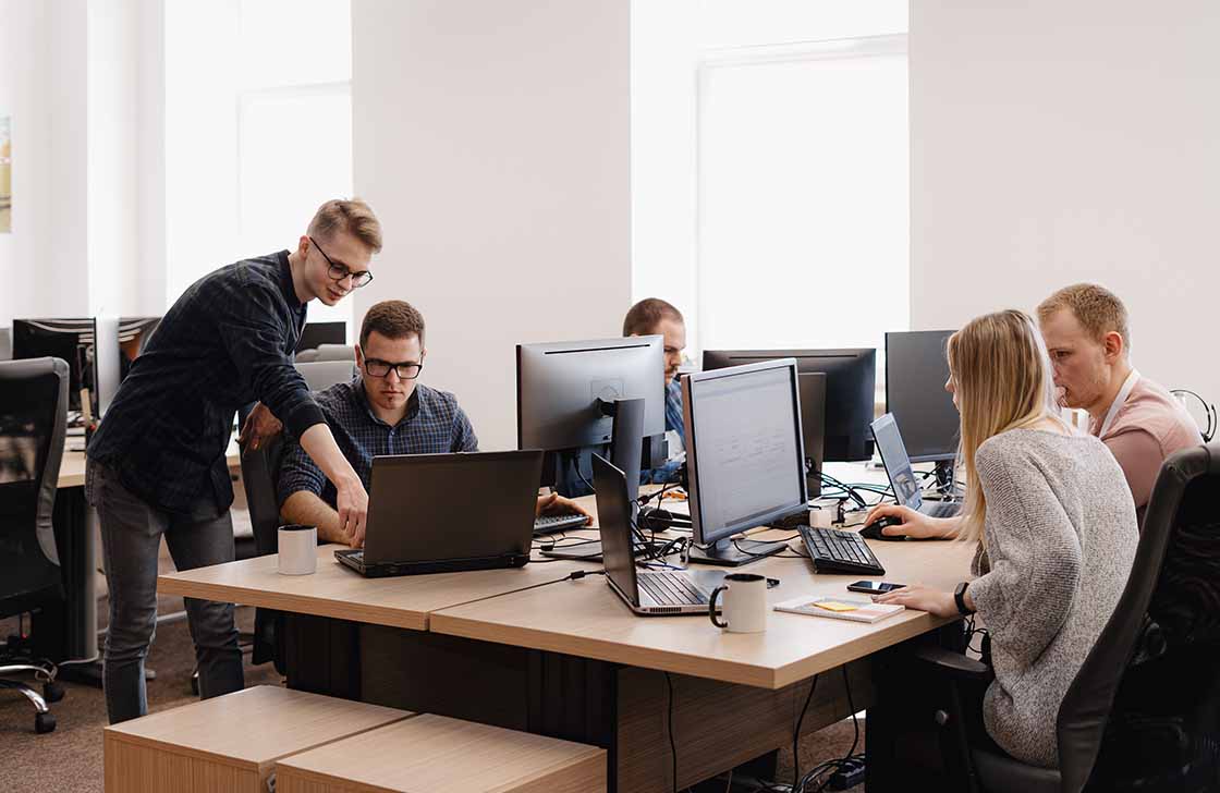 Group of young software workers in the SaaS office company.